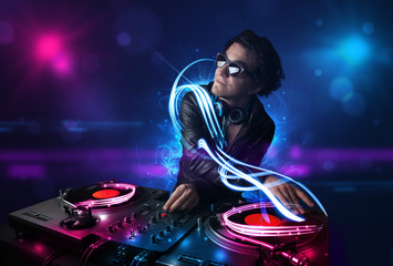 Disc jockey playing music with electro light effects and lights