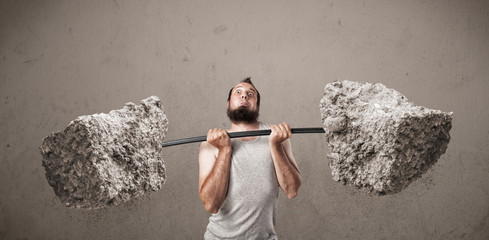 skinny guy lifting large rock stone weights
