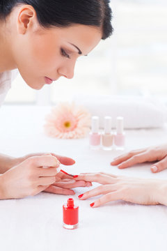 Making red manicure.