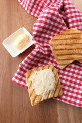 Grilled bread with butter on wooden table