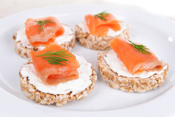 Delicious canapes on plate close-up