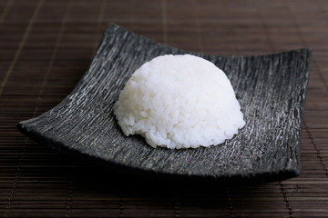 Cooked rice on bamboo background