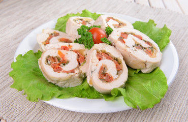 Delicious chicken roll on plate on table close-up