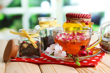 Assortment of herbs, honey and tea in glass jars