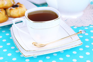 Cup of tea with sweet pastries on table close-up