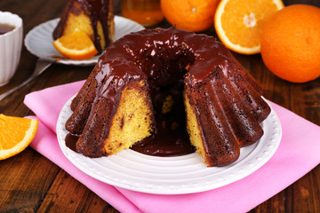 Tasty homemade pie with oranges on table close-up