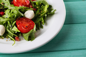 Green salad made with  arugula, tomatoes, cheese mozzarella