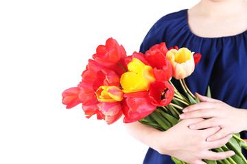 Colorful tulips in female hands isolated on white