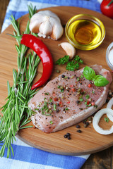 Raw meat steak with herbs and spices