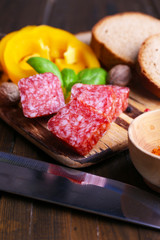Composition with knife,  tasty salami sausage, sliced bread and
