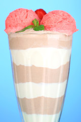 Tasty chocolate mousse with sorbet on blue background