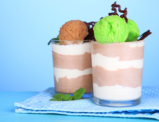 Tasty chocolate mousse with sorbet on blue background