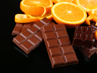 Chocolate and orange on black background