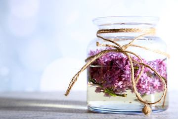 Obraz na płótnie Canvas Beautiful lilac flowers in glass jar,