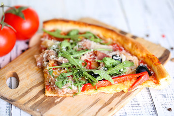 Piece of pizza with arugula