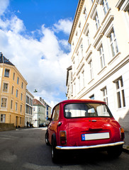 Fototapeta na wymiar Old red car in a street