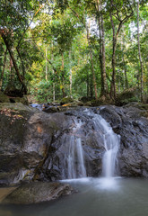 Naklejka na ściany i meble Evergreen forest waterfall in Chanthaburi, Thailand