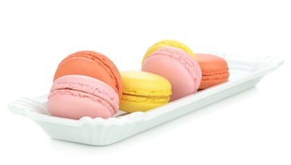 A plate of traditional french macaroons on a white background