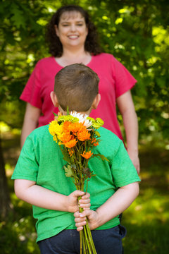 Little Boy Giving Flowers To His Mom On Mother's Day