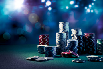 Casino chips with dramatic lighting and lens flares - 64553710