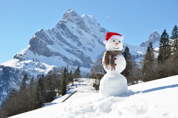 Snowman against Alpine panorama