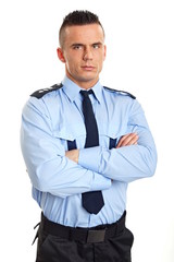 Portrait of young strict man standing in police uniform