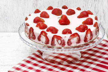 Strawberry cake on cake stand. Grey wooden background, copy spac