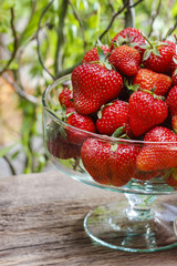 Fresh ripe strawberries in glass bowl