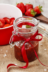 Strawberry jam in preserving glass