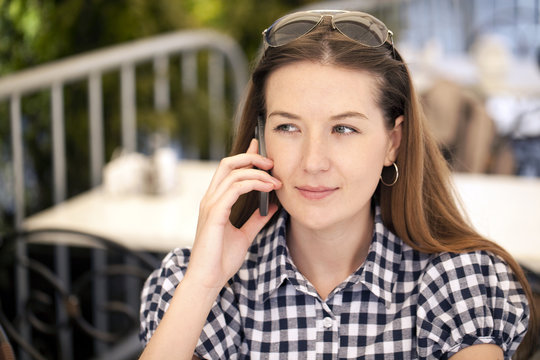 Happy woman talking on cell phone