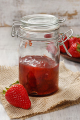 Strawberry jam in preserving glass