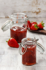 Strawberry jam in preserving glass
