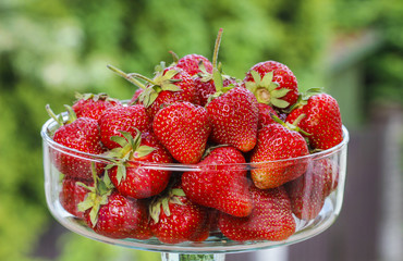 Fresh ripe strawberries in glass bowl