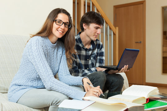 Student couple preparing for exam at home