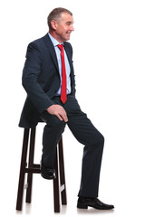 business man sits and smiles