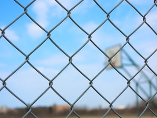 Metal mesh with blur basketball court background