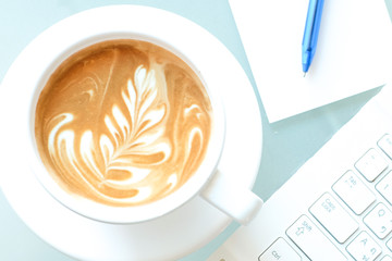 a cup of coffee and a laptop