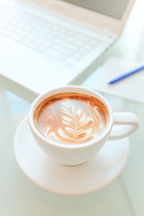 a cup of coffee and a laptop