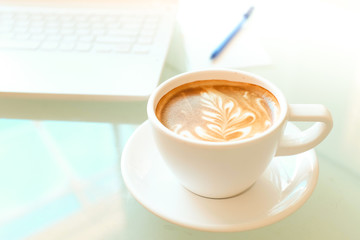 a cup of coffee and a laptop