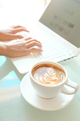 a cup of coffee and a laptop