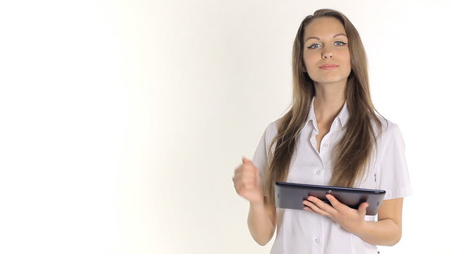 Beautiful girl shows information from the tablet on a white