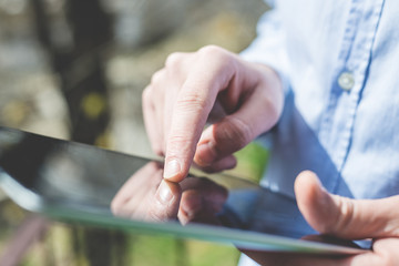 close up hands multitasking man using tablet