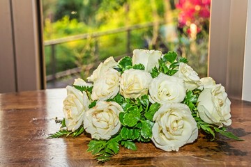 Bouquet of white roses and green leaves