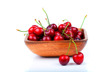 cherry berry in wooden bowl, isolated on white background