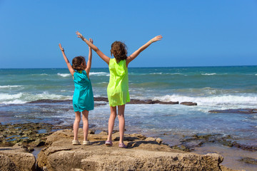 Happy kids on ocean beach having fun