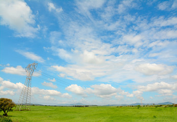 clouds over a transmission tower
