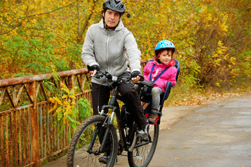 Fototapeta na wymiar Father and kid on bike, cycling in autumn park