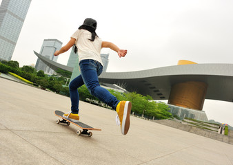  skateboarding woman speeding in city - obrazy, fototapety, plakaty