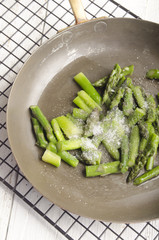 cooked asparagus in a pan with sugar