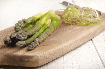 raw asparagus on a wooden board